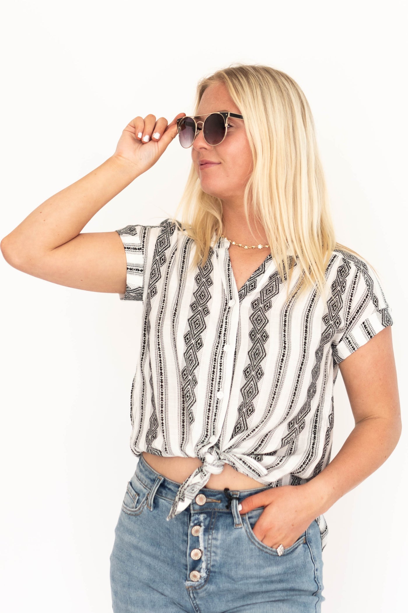 Front view of a short sleeve white top with a black pattern
