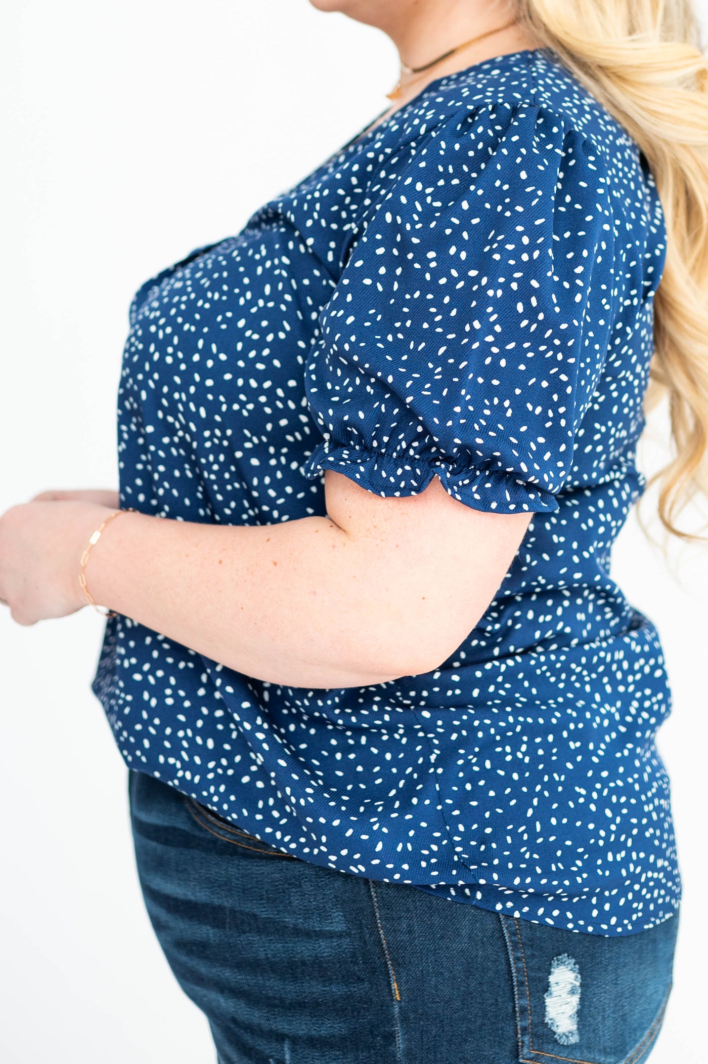 Side view of a plus size navy top
