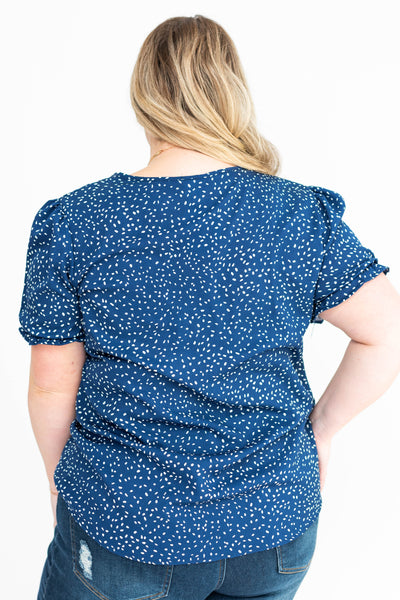Back view of a plus size navy top