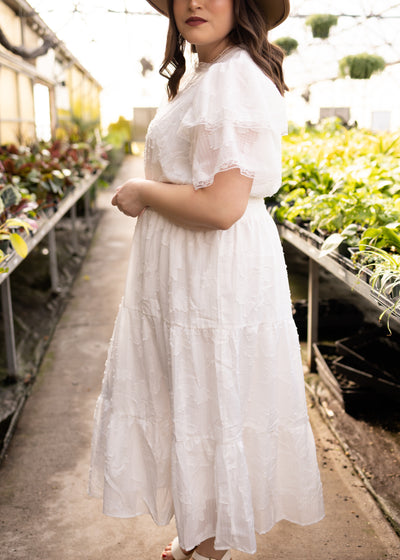 Side view of a plus size white floral dress