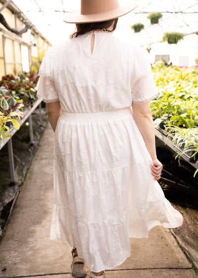 Back view of a plus size white floral dress