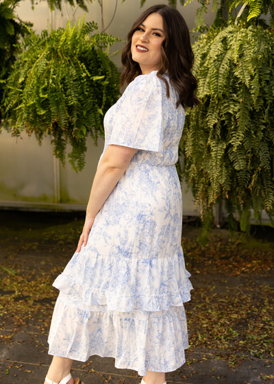 Side view of a plus size blue floral dress