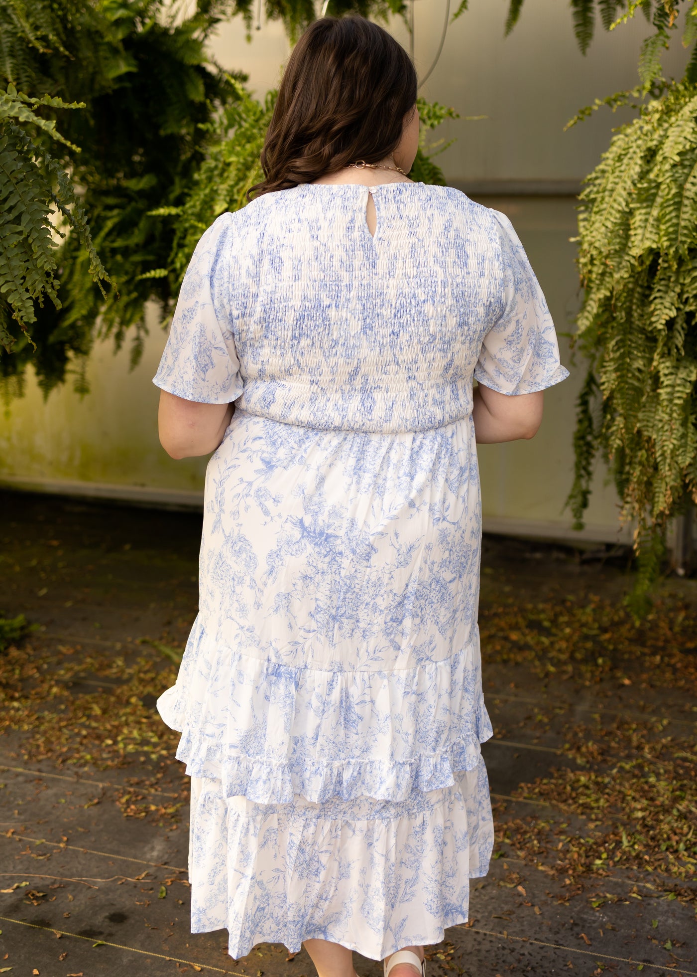 Back view of a plus size blue floral dress