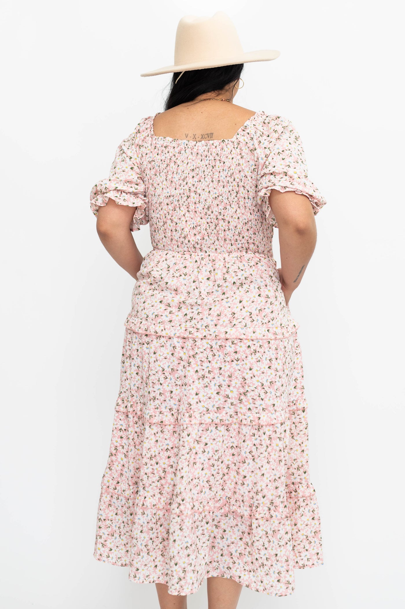 Back view of a pick floral dress
