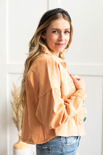 Side view of a orange jean jacket