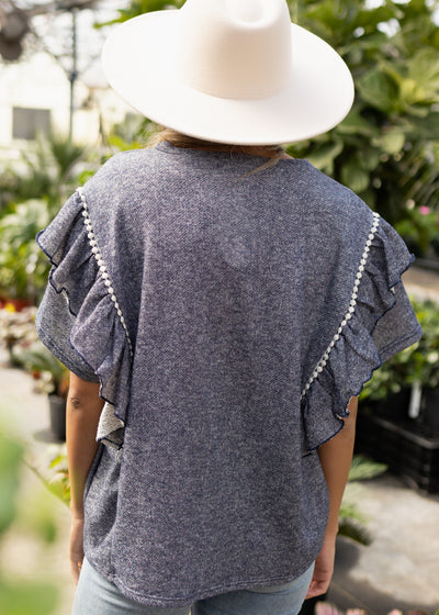 Back view of a denim blue top