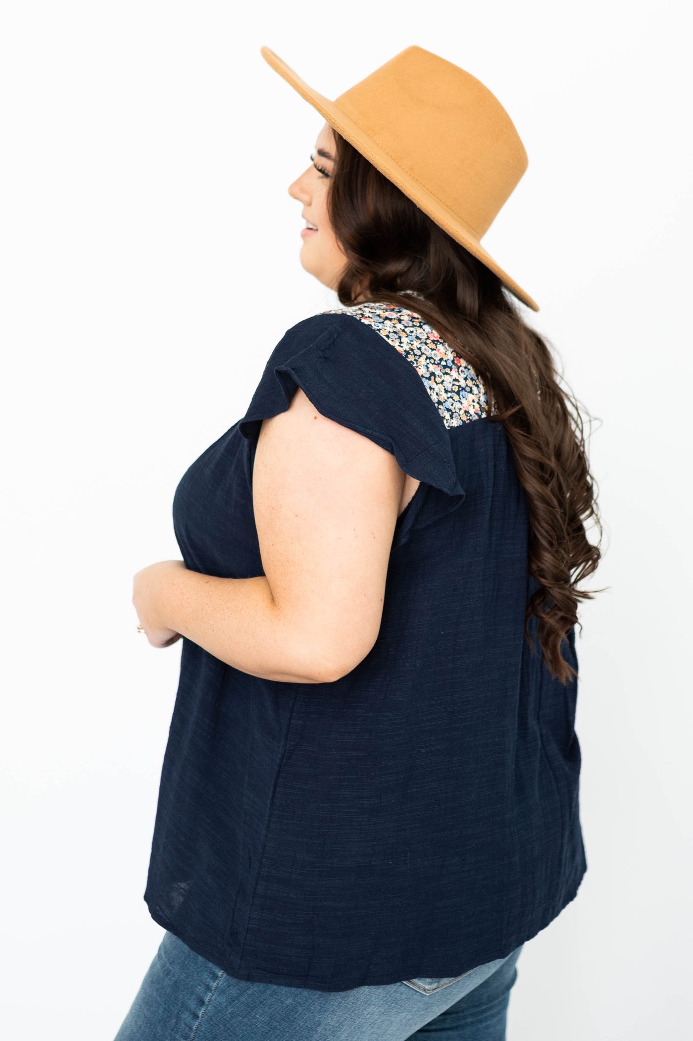 Side view of a plus size ivory top