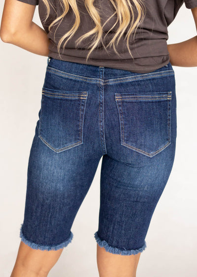 Back view of indigo Bermuda shorts