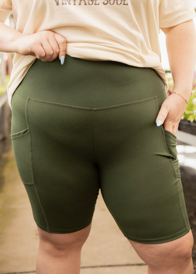 Front view of plus size army green biker shorts with pockets