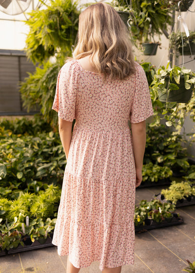 Back view of a blush floral dress