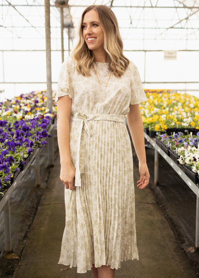 Short sleeve sage floral dress with pleated skirt and ties at the waist