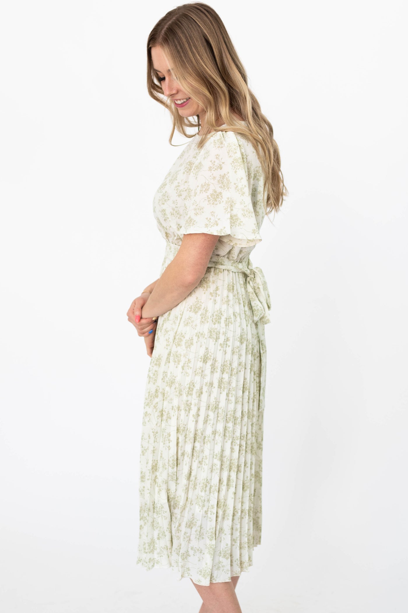 Side view of a short sleeve sage floral dress