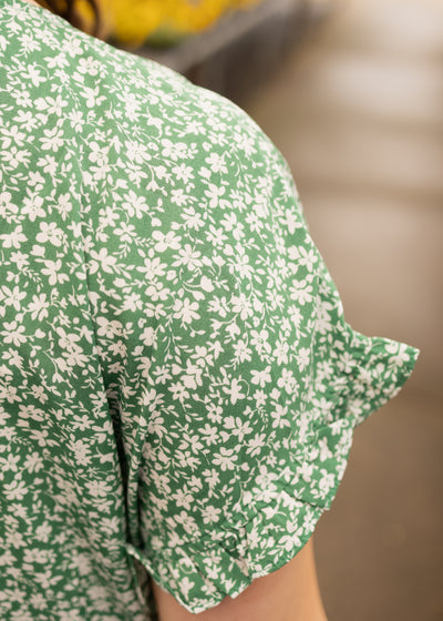 Sleeve ruffle of a green floral dress