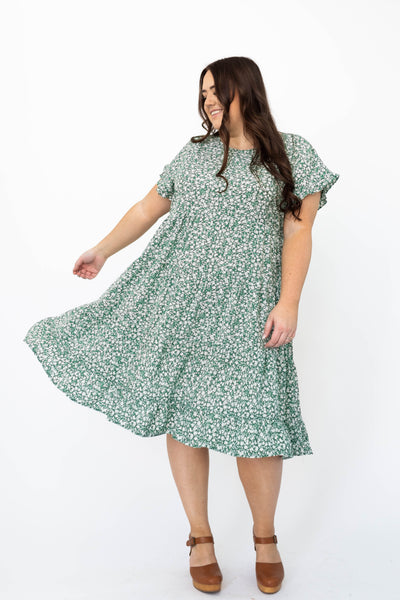 Cap sleeve green floral dress with ruffle at the hem and the cuffs