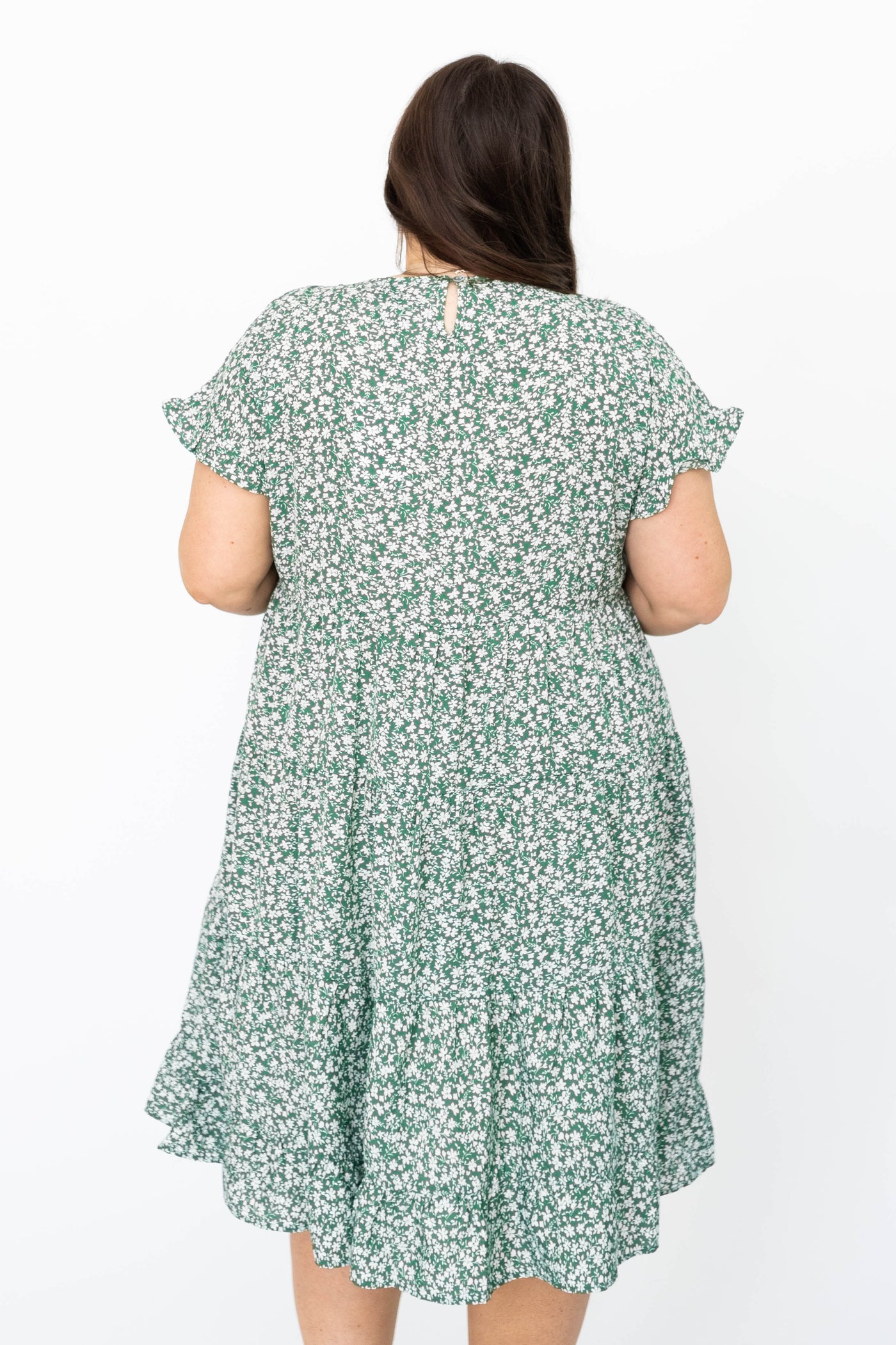 Back view of a plus size green floral dress