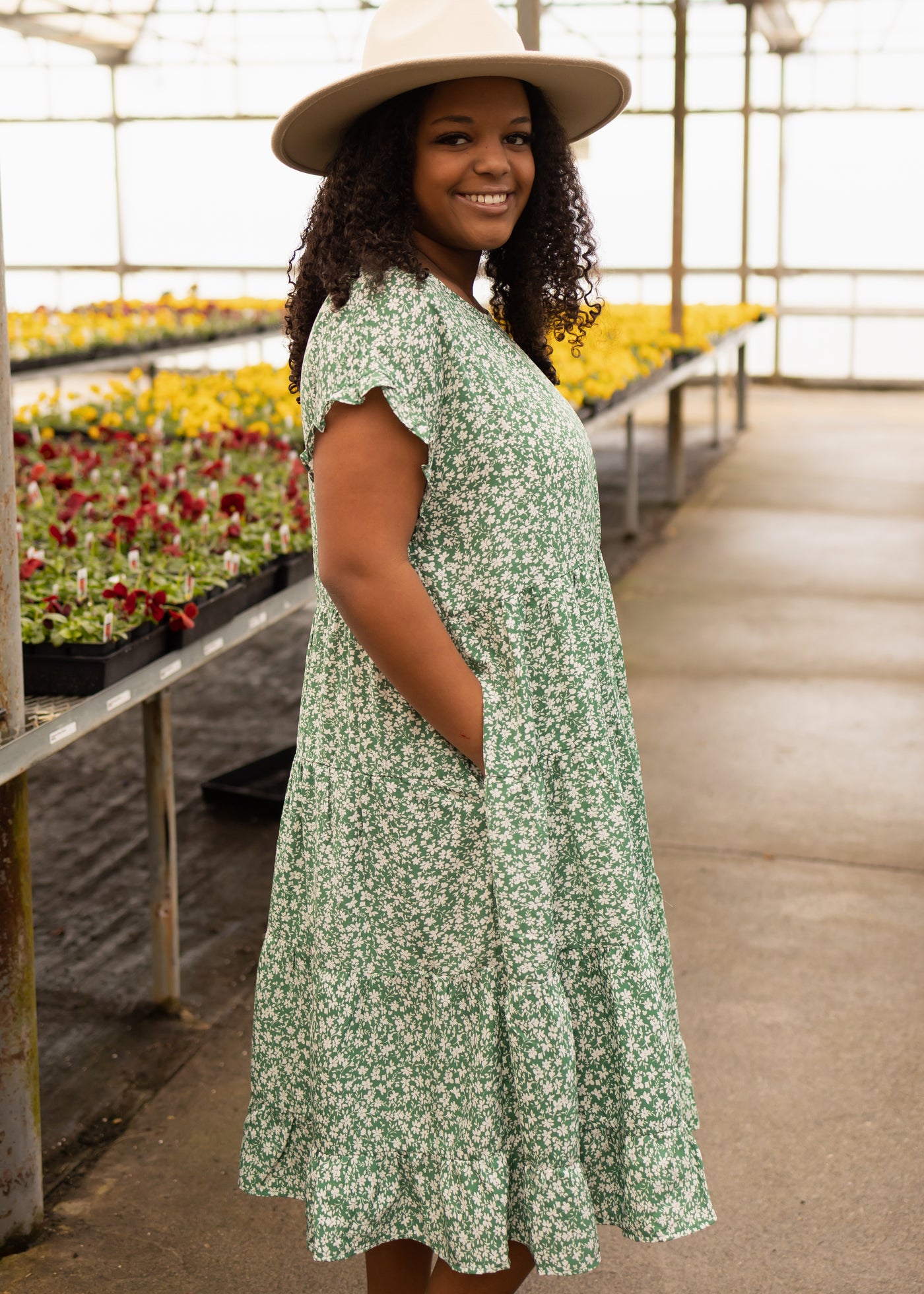 Side view of a green floral dress with pockets