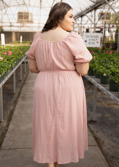 Back view of a plus size dusty pink dress