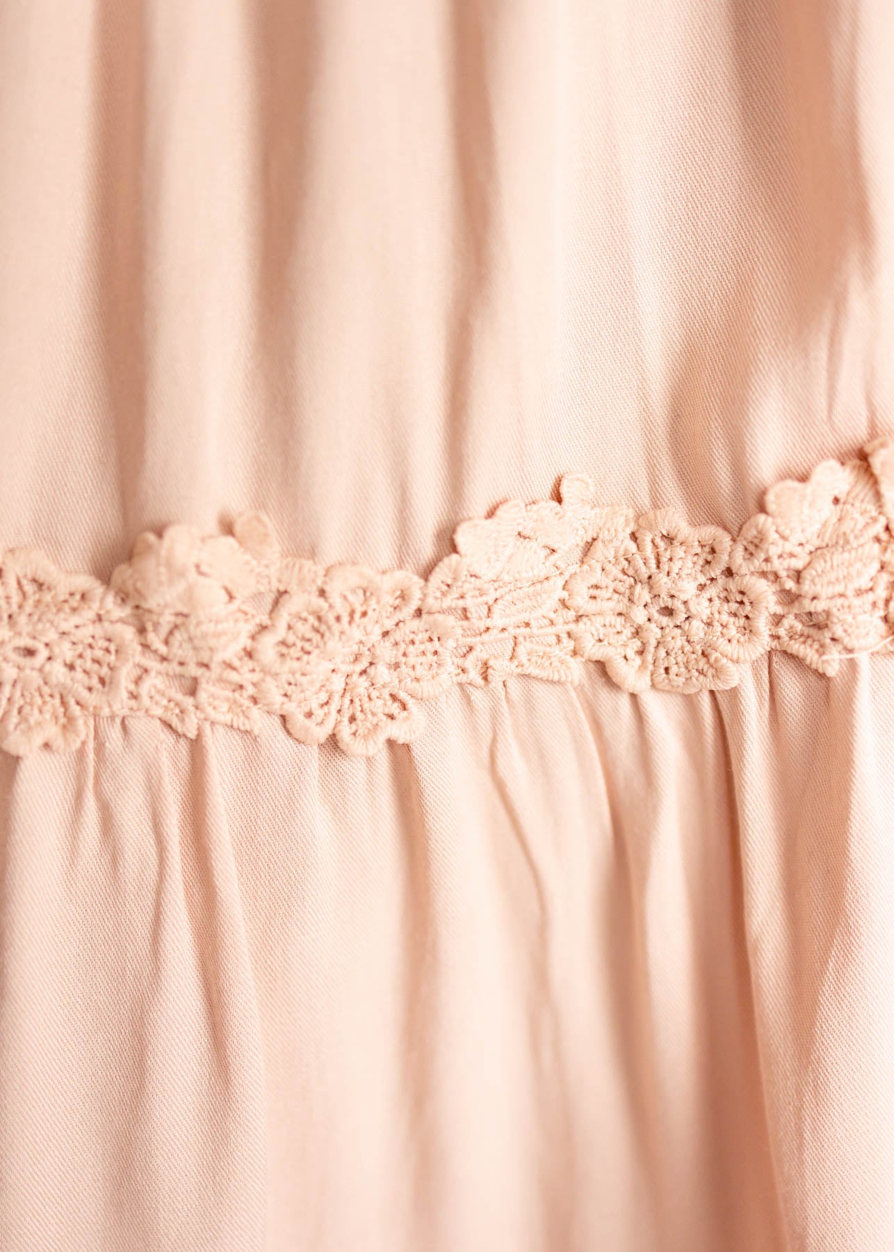 Lace trim on a blush dress