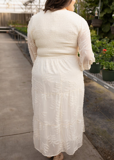 Back view of a plus size cream dress