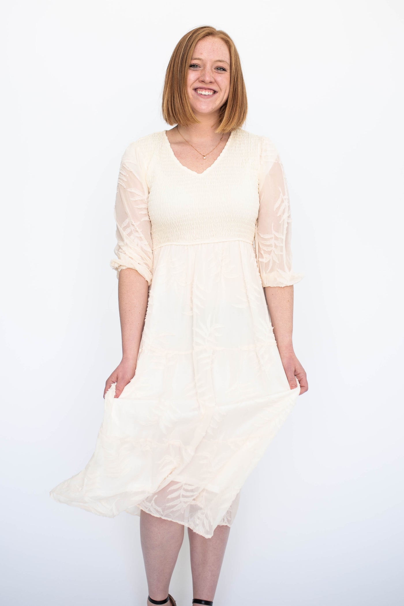 Short sleeve cream dress with a smocked bodice