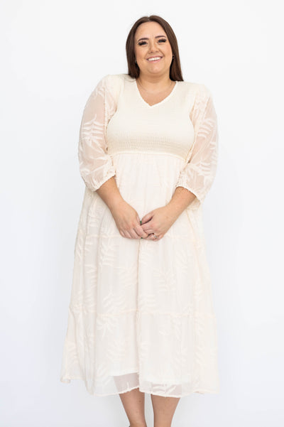 Cream dress with short sleeves and smocked bodice