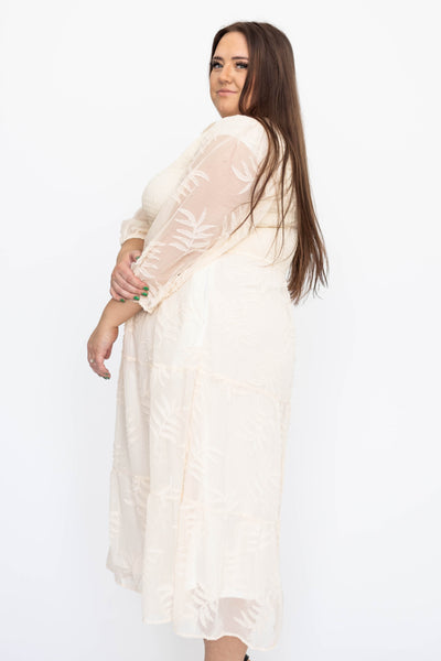 Side view of a plus size cream dress