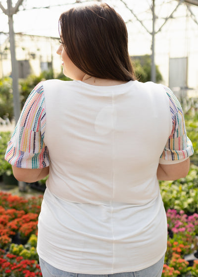 Back view of a white top with colorful sleeves