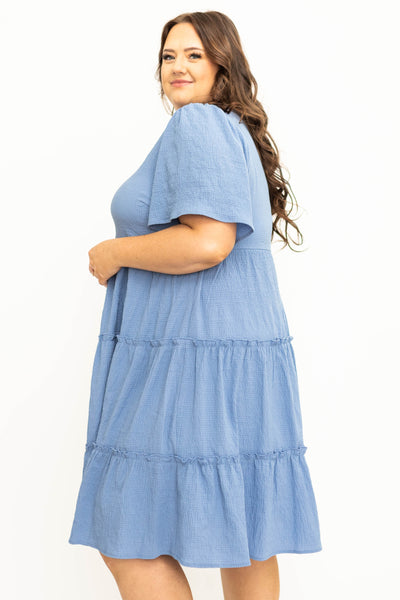 Side view of a plus size blue tiered dress