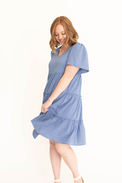 Knee length blue dress with tiered skirt