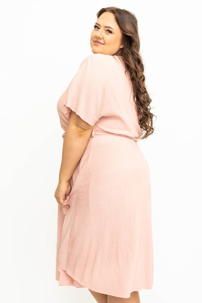 Side view of a plus size pink dress