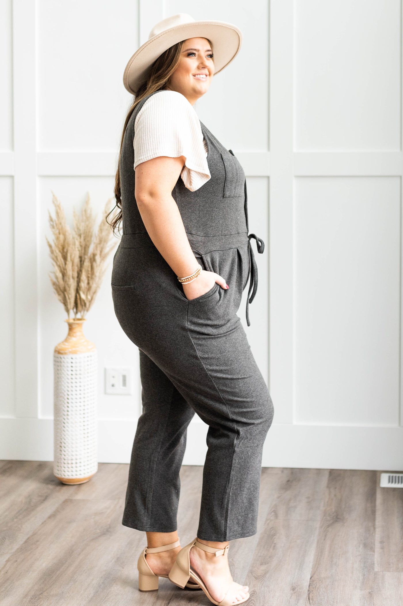 Side view of a plus size charcoal jumpsuit