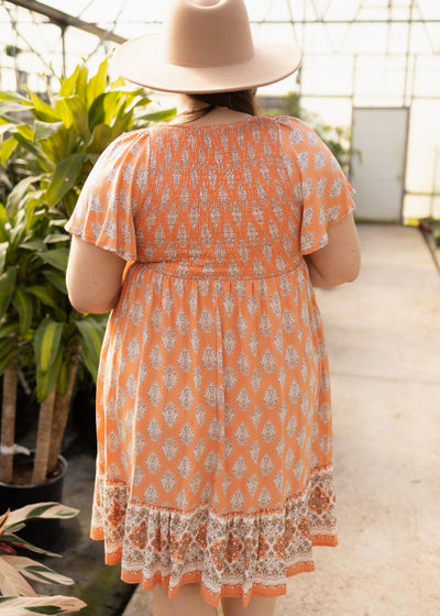 Back view of a plus size tangerine dress