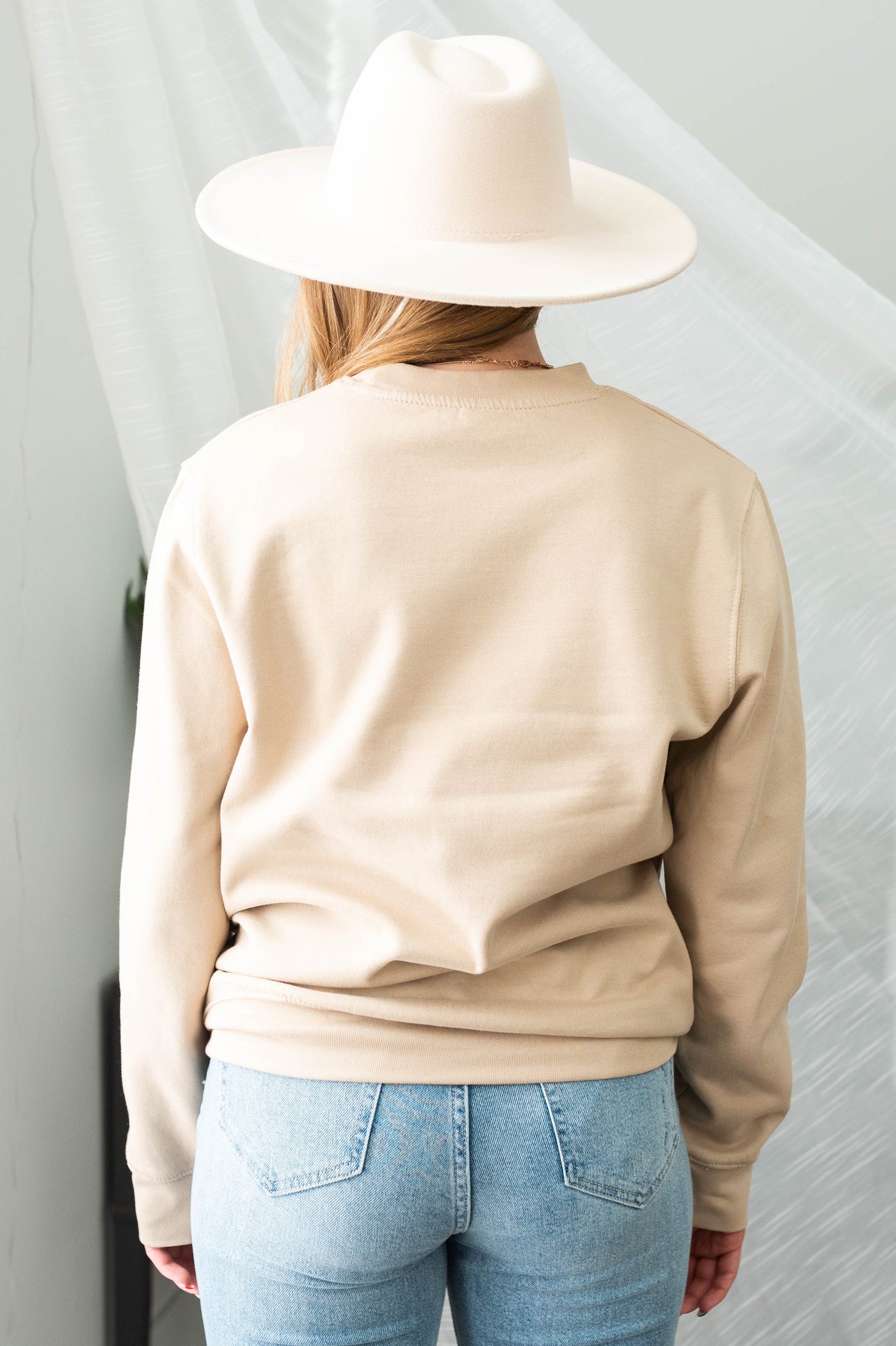 Back view of a sand sweatshirt