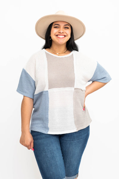 Front view of a blue knit top