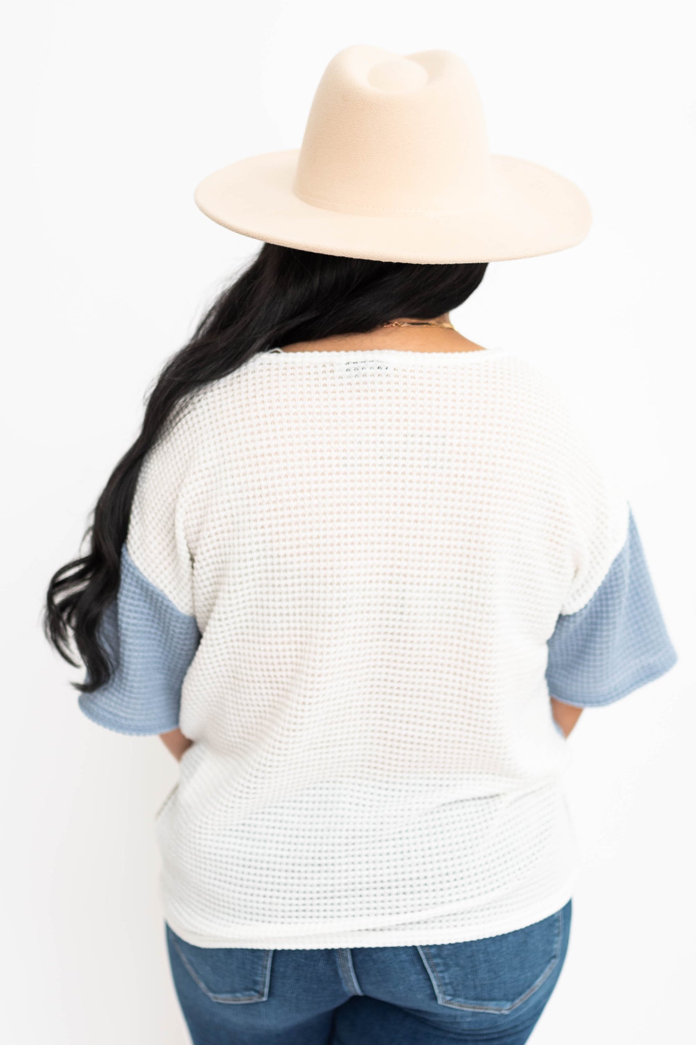  Back view of a blue knit top