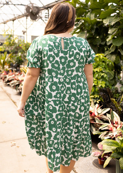 Back view of a plus size green floral dress