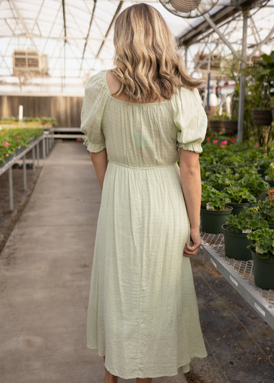 Back view of a short sleeve sage dress