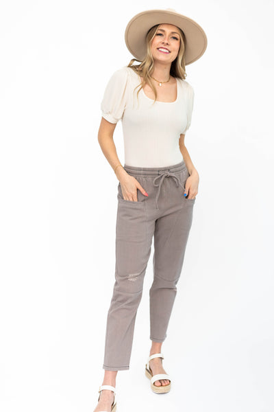 Front view of dusty lilac pants with pockets and tie at the waist