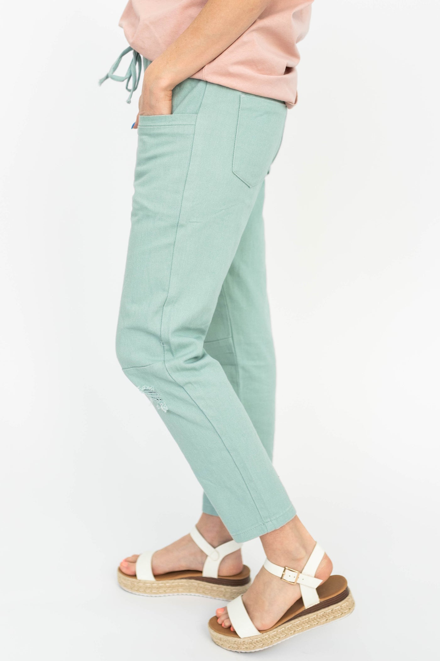 Side view of mint pants with pockets