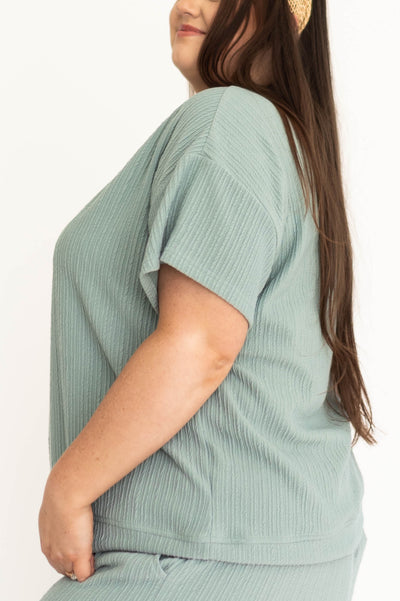 Side view of a dusty sage top with short sleeves