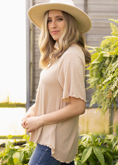 Side view of a short sleeve beige top
