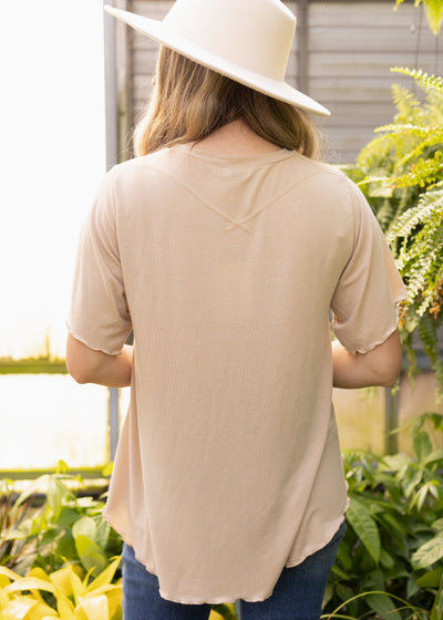 Back view of a short sleeve beige top