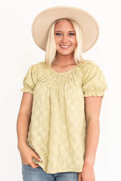 Front view of a short sleeve sage top