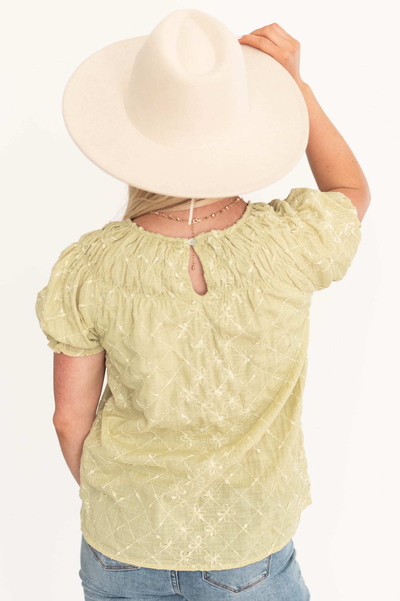 Back view of a short sleeve sage top