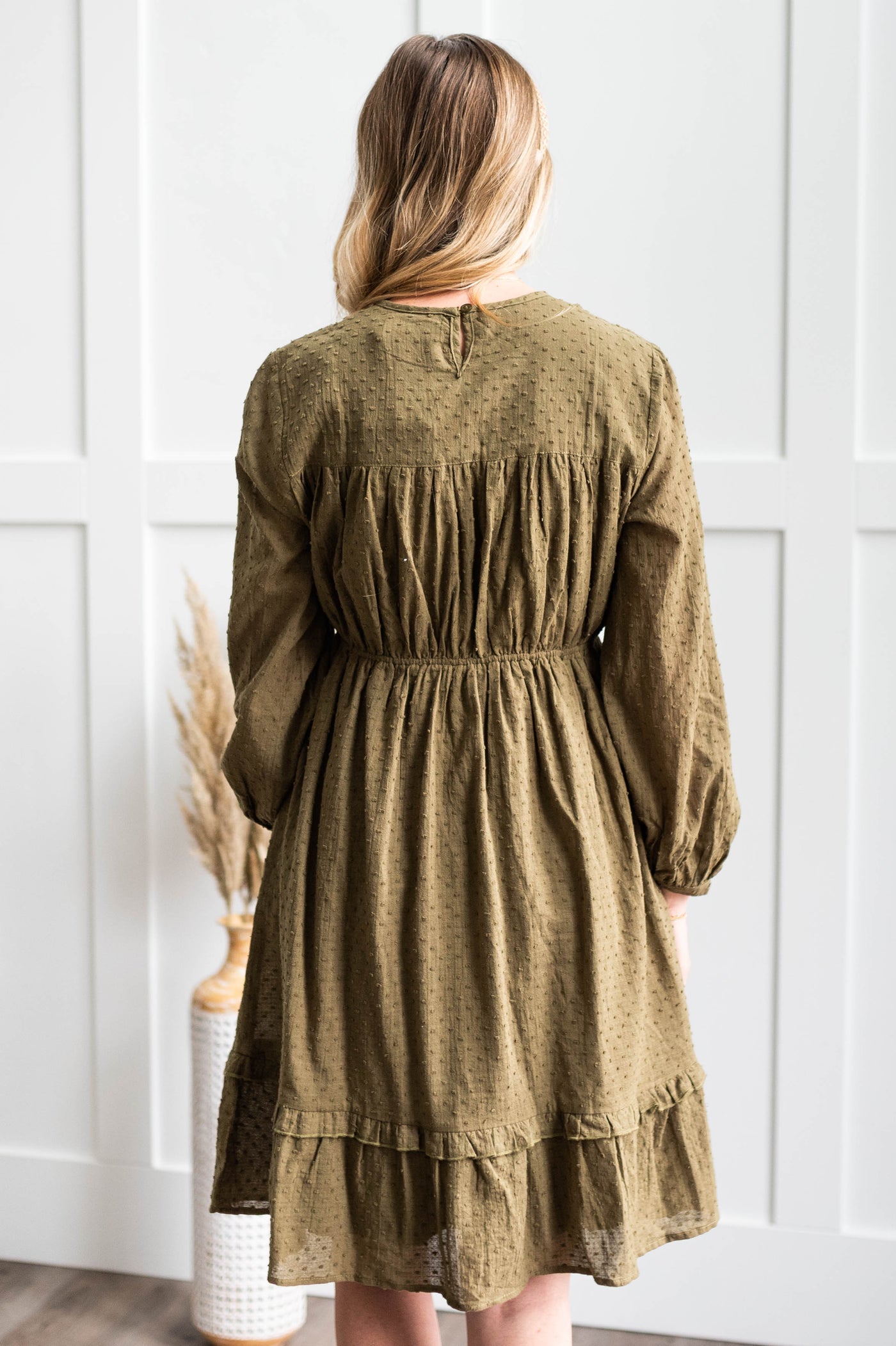 Back view of a olive dress with elastic waist