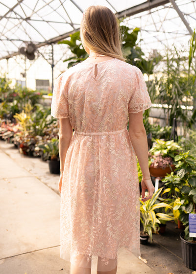 Back view of a peach floral dress