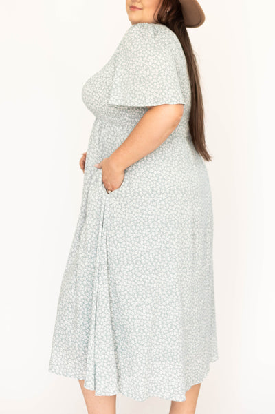 Side view of a plus size sage floral dress