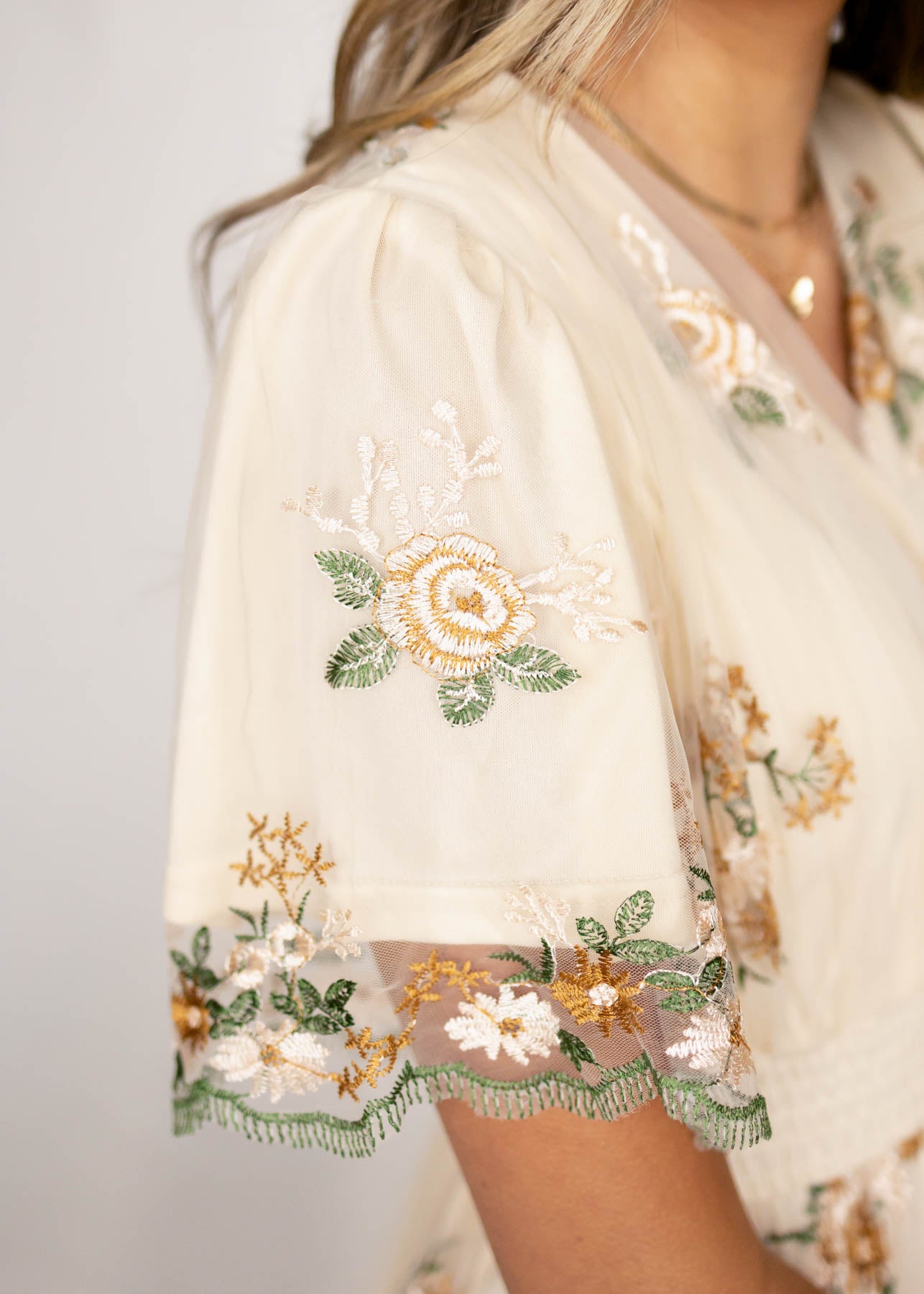 Sleeve view of a taupe dress
