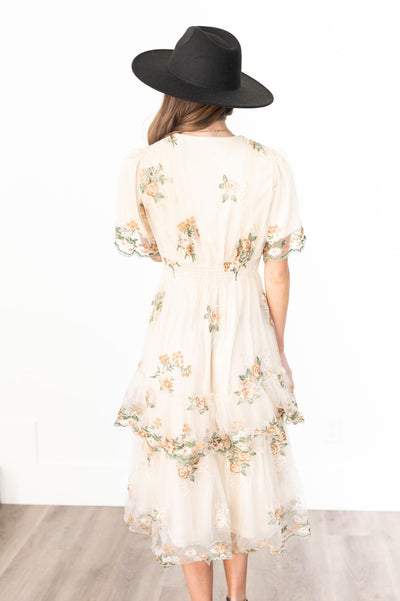 Back view of a wild flower taupe dress