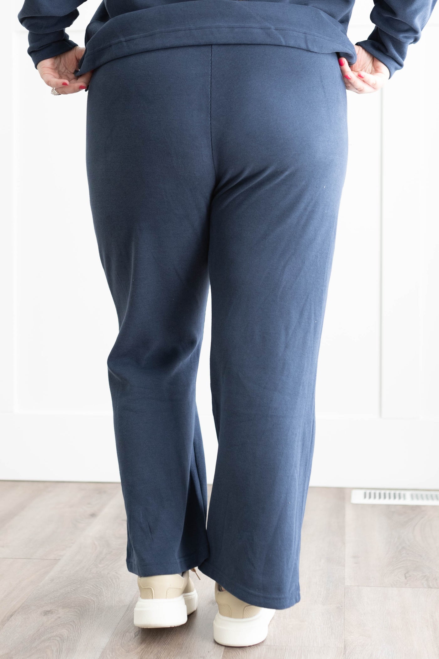 Back view of the pants on a plus size navy set